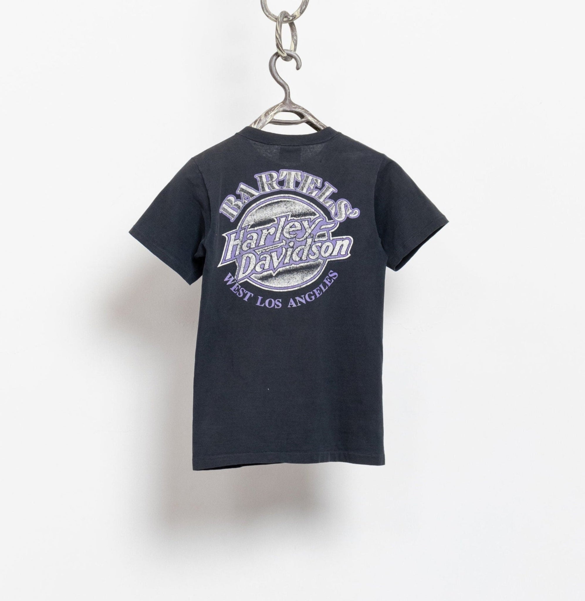 Black t-shirt with Harley Davidson logo on a hanger against a white background