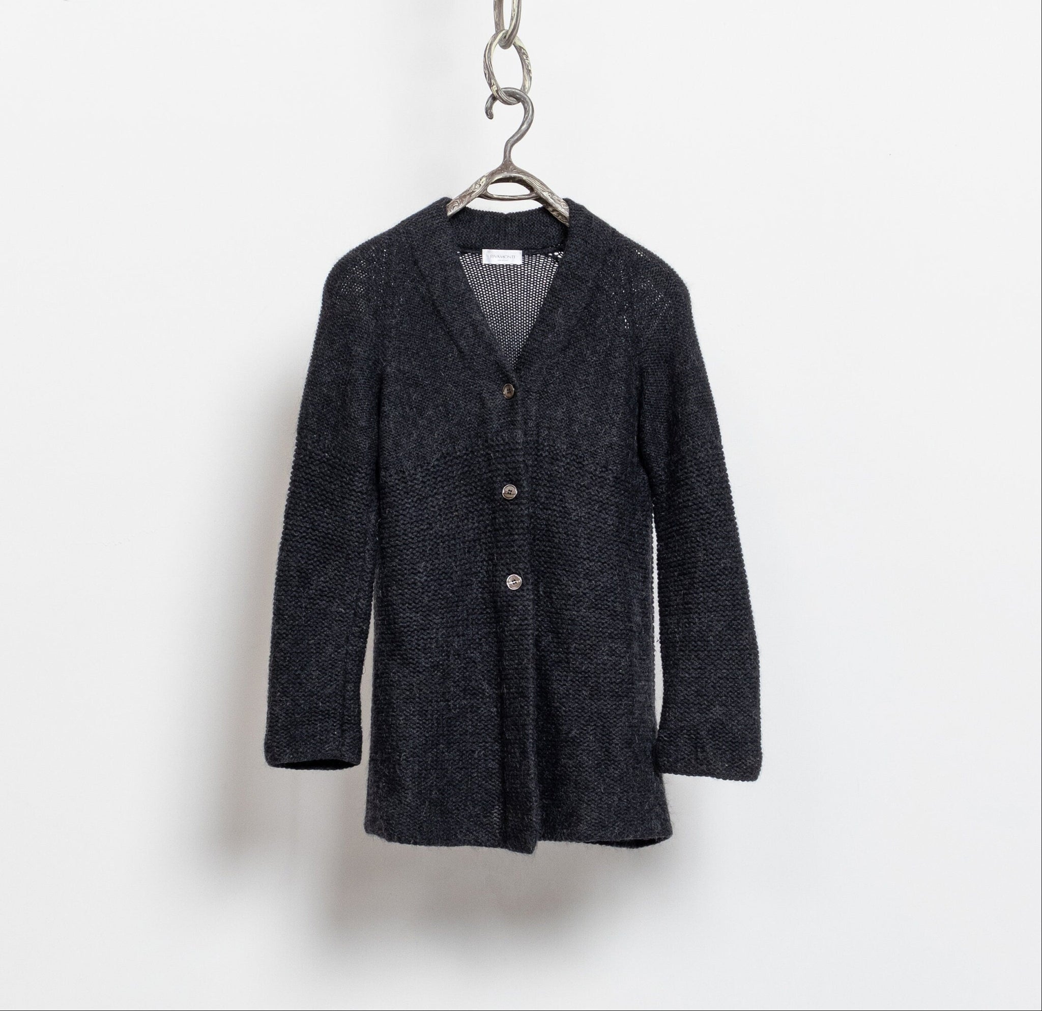 A vintage 90's silk-wool-blend fuzzy cozy cardigan in deep, dramatic black / dark grey, with buttons down the front and a deep V-neck.