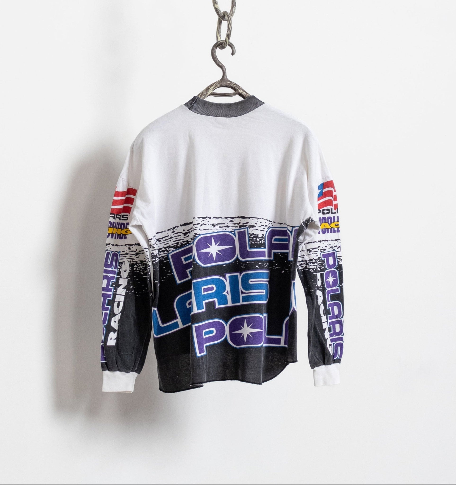 Long-sleeve shirt with Polaris Racing logo on a hanger against a white background