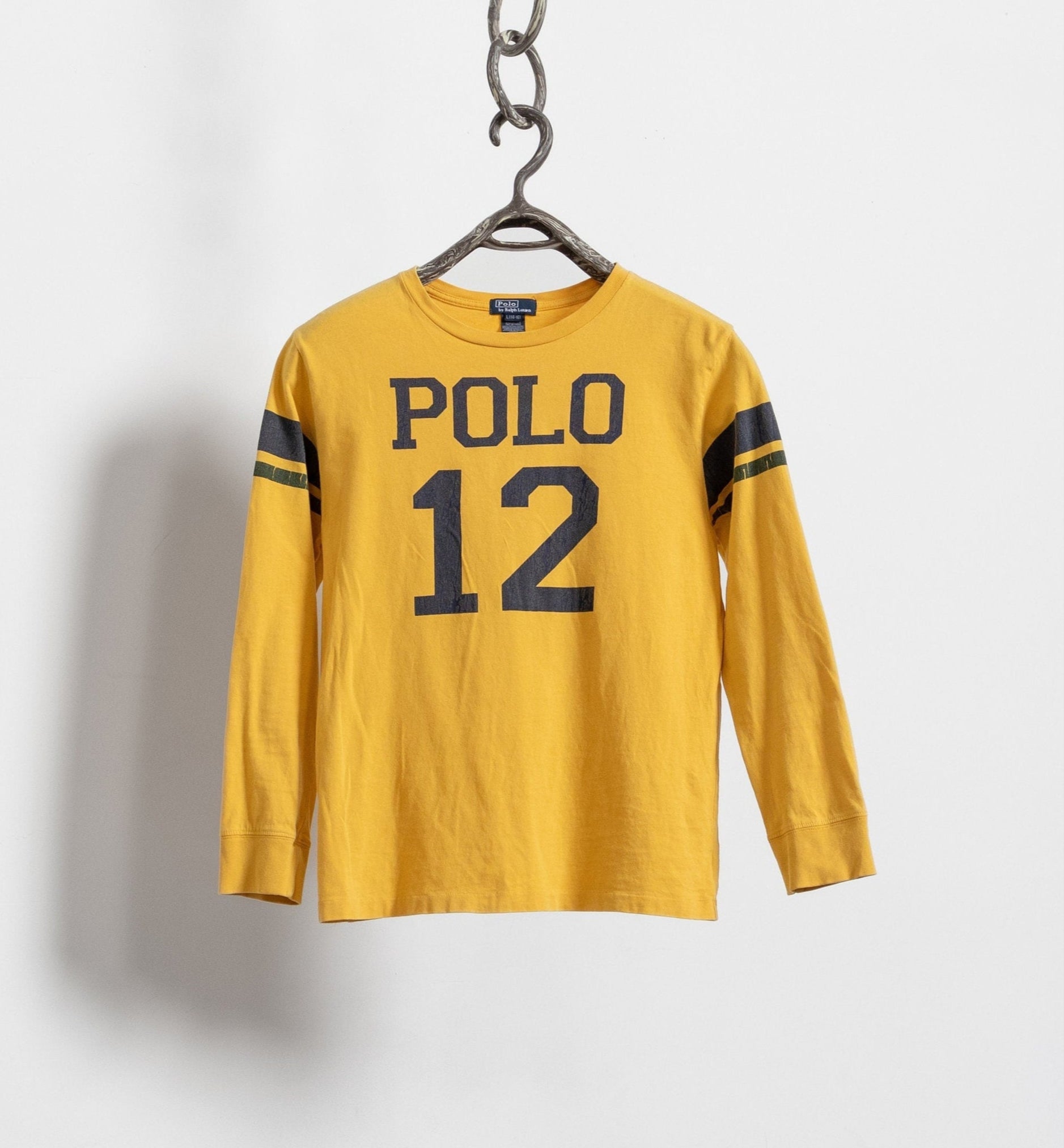 A long sleeve yellow graphic t-shirt with the text 'POLO 12' printed on the front, displayed on a white background.