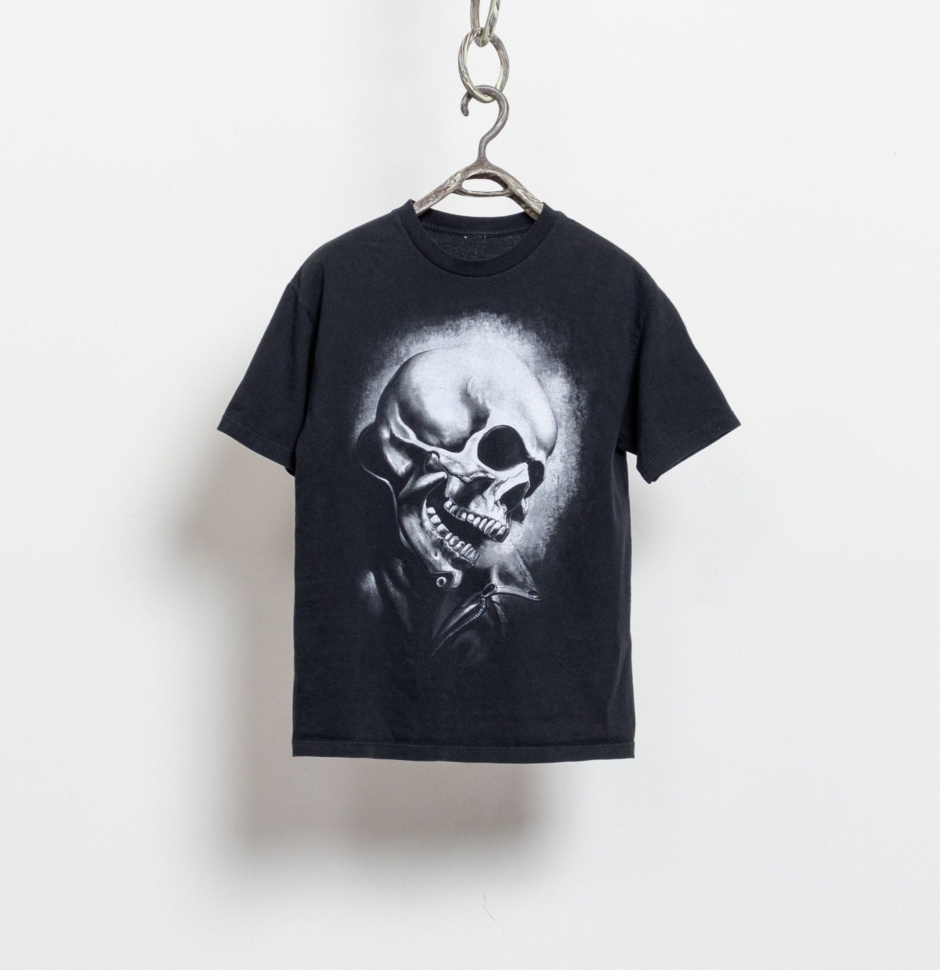 Black t-shirt with a skull graphic on a white background