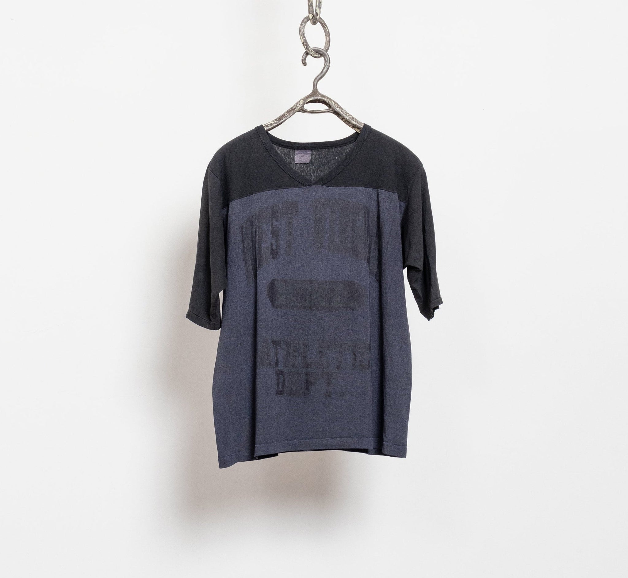 Black t-shirt with text on a hanger against a white background